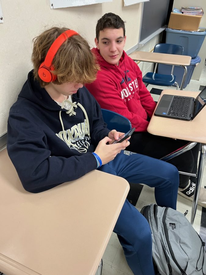 On January 10th, 2023 at 11:07 am, Roxbury High School student Nicho Blehl is caught trying to start a conversation with Espen Sears in study hall. Espen is playing a soccer game on his phone while listening to music, and not at all acknowledging Nicho next to him.