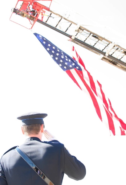 A Police Officer salutes the American flag.