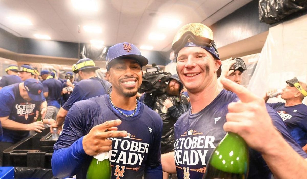 Mets' Francisco Lindor and Pete Alonso celebrating with the team in the locker room after they beat the Braves.