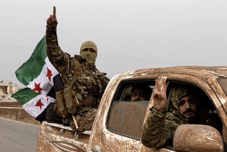 Syrian Rebels celebrate the victory over the Syrian dictator Bashar al-Assad.